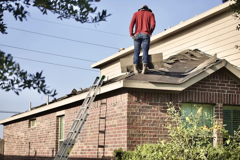 Professional roofer working on a residential roof in Bayshore Reserve